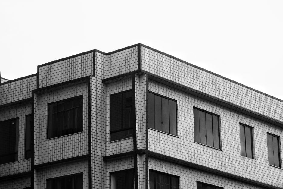 Black and white photo of modern building facade with geometric design.