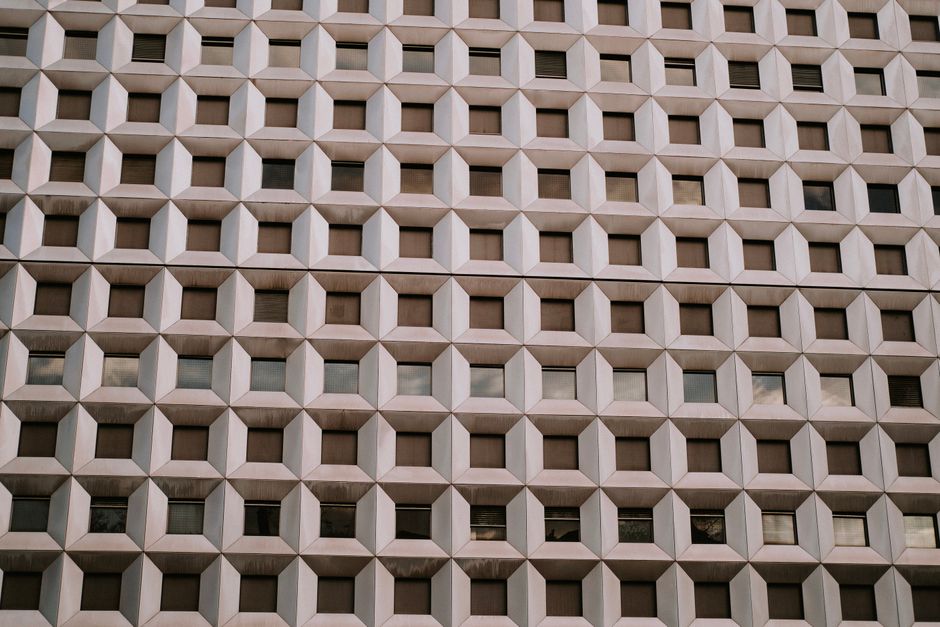 Close-up of a modern building facade showing geometric patterns and textures.